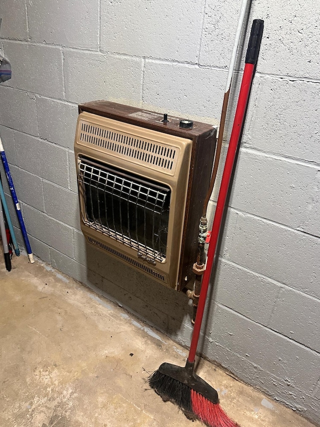 room details featuring heating unit and concrete floors