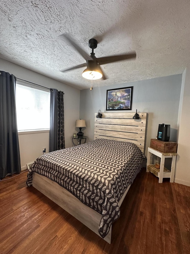 bedroom featuring ceiling fan, baseboards, a textured ceiling, and wood finished floors