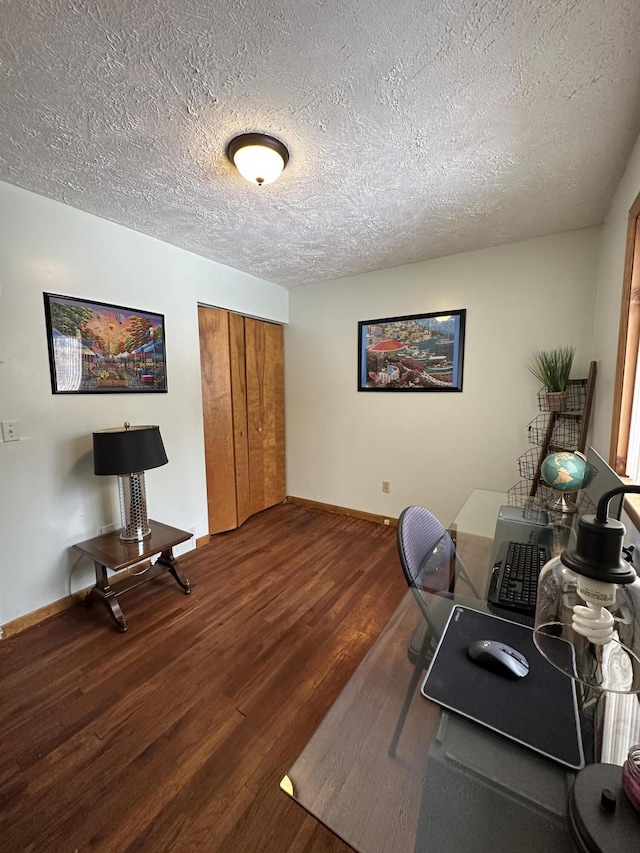 office featuring wood finished floors, baseboards, and a textured ceiling