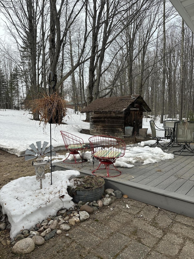 snow covered deck with an outdoor structure