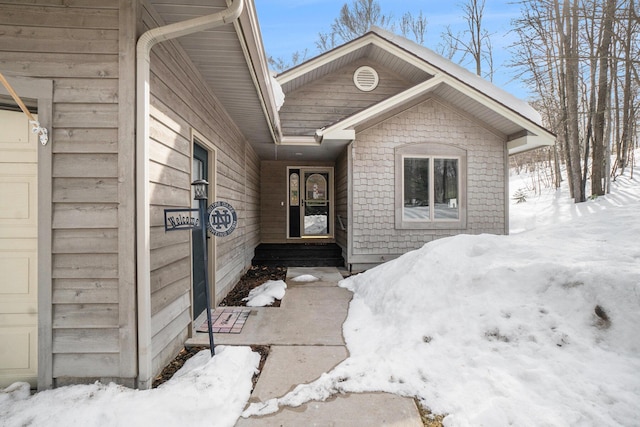 view of snow covered property entrance