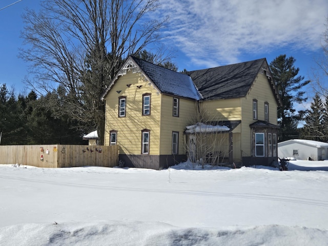 snow covered property featuring fence