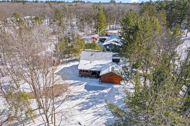 snowy aerial view with a view of trees