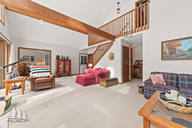 carpeted living room with beam ceiling, high vaulted ceiling, and stairs