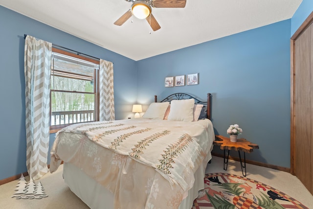 bedroom with a closet, baseboards, carpet floors, and ceiling fan