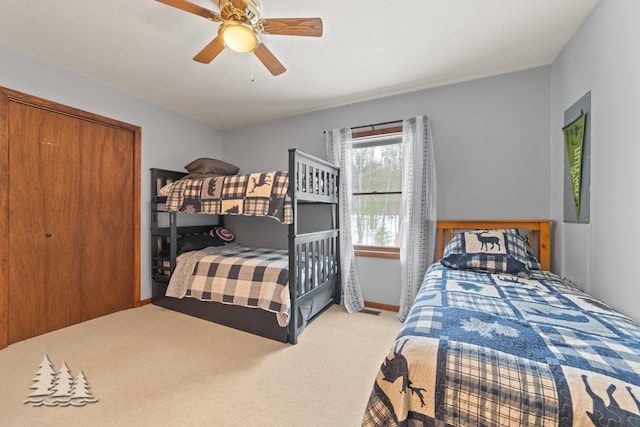 bedroom featuring baseboards, a ceiling fan, and carpet