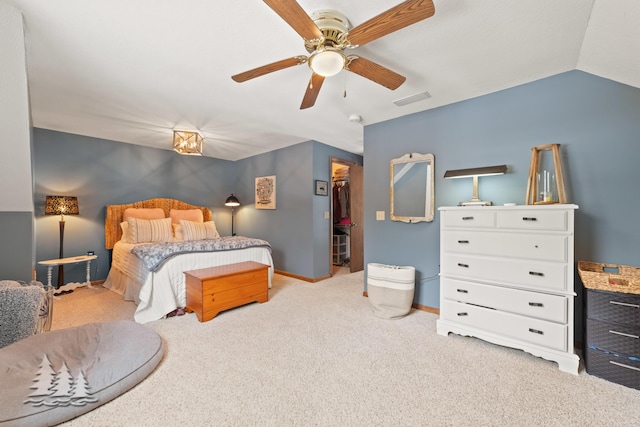 bedroom featuring visible vents, lofted ceiling, a closet, baseboards, and a spacious closet