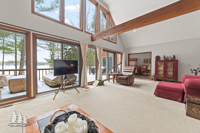 living area with visible vents, carpet floors, high vaulted ceiling, and beam ceiling