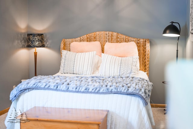 carpeted bedroom featuring baseboards