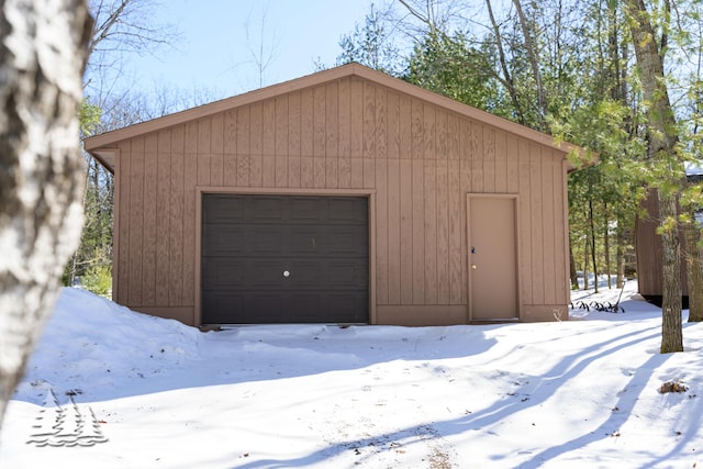 snow covered garage with a garage