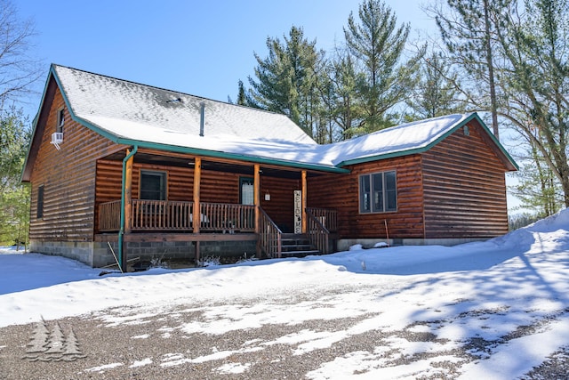 log cabin with log veneer siding and a porch