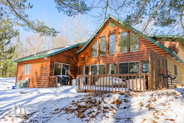 view of snow covered rear of property