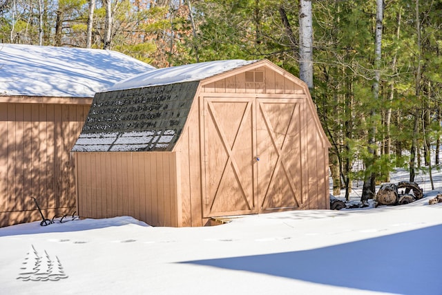 snow covered structure with an outdoor structure