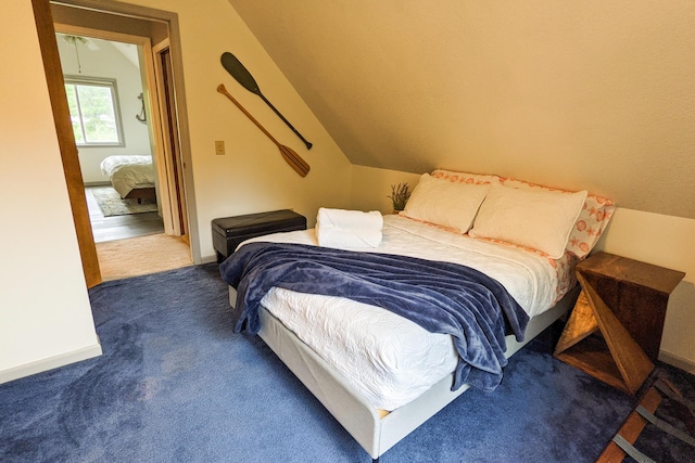 carpeted bedroom featuring vaulted ceiling