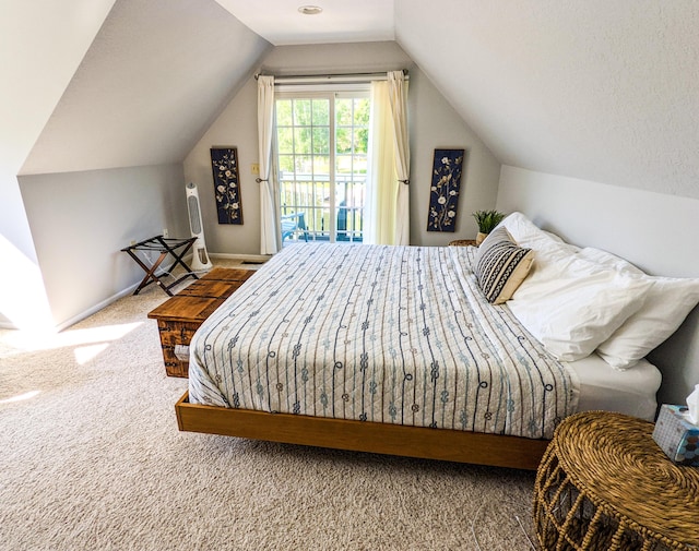 bedroom featuring access to exterior, baseboards, lofted ceiling, carpet flooring, and a textured ceiling