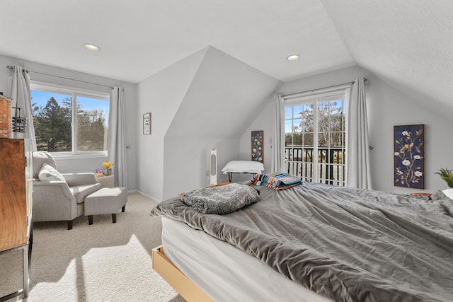 bedroom featuring access to exterior, vaulted ceiling, multiple windows, and carpet floors