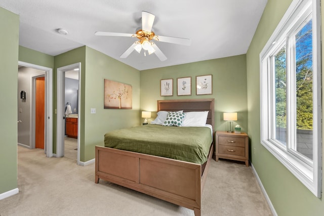 bedroom featuring baseboards, multiple windows, and light carpet