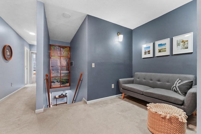 interior space with carpet, an upstairs landing, and baseboards