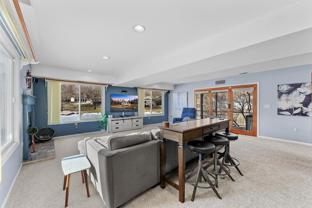 living area featuring visible vents, light carpet, recessed lighting, french doors, and baseboards