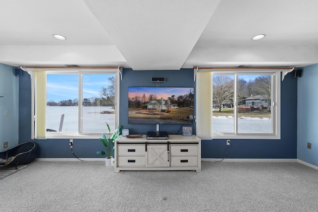 unfurnished living room with recessed lighting, carpet, and baseboards