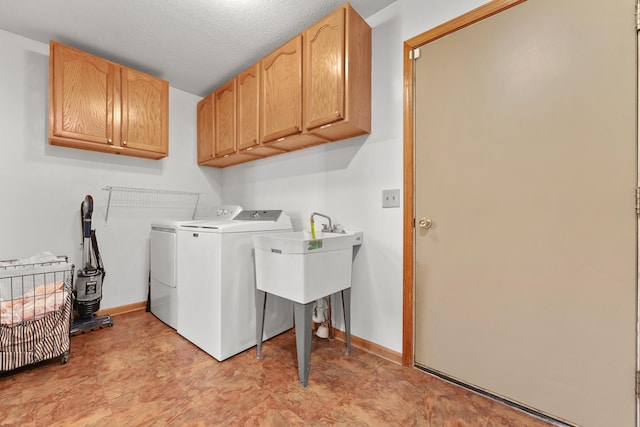 laundry room with cabinet space, independent washer and dryer, and baseboards