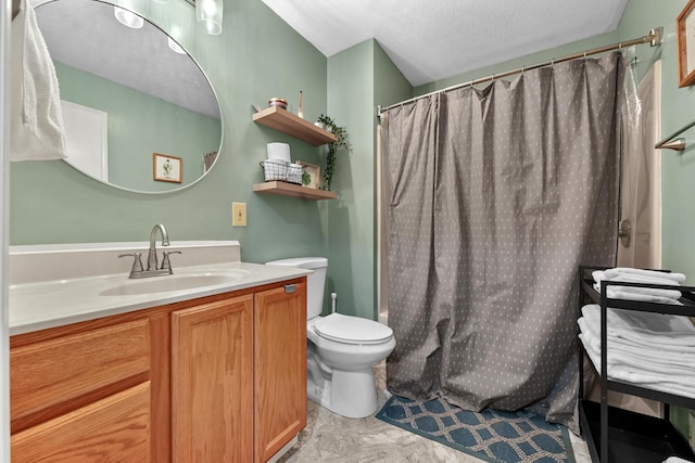 full bathroom with toilet, vanity, and a textured ceiling