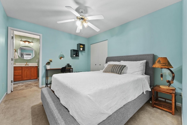 bedroom with light colored carpet, baseboards, ceiling fan, and a sink