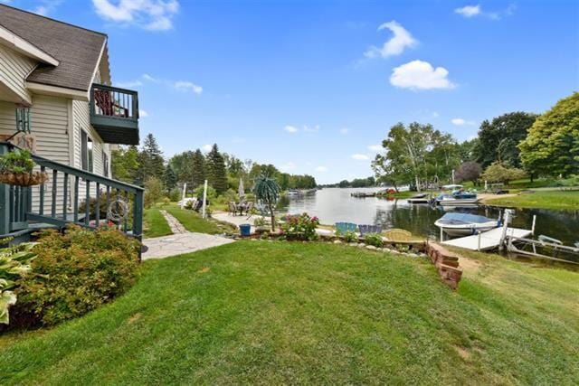 view of yard featuring a dock and a water view