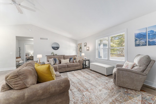 living room with visible vents, wood finished floors, baseboards, lofted ceiling, and ceiling fan