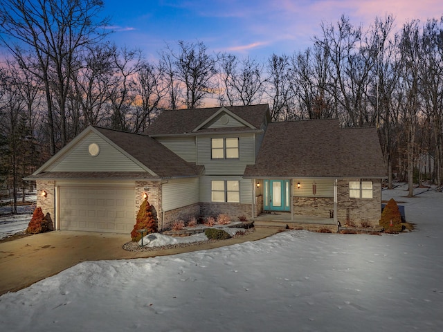 view of front of home with driveway and a garage