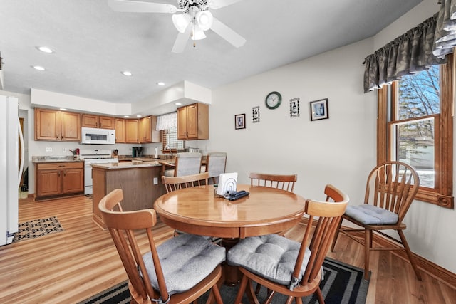 dining space featuring recessed lighting, light wood-type flooring, baseboards, and a ceiling fan