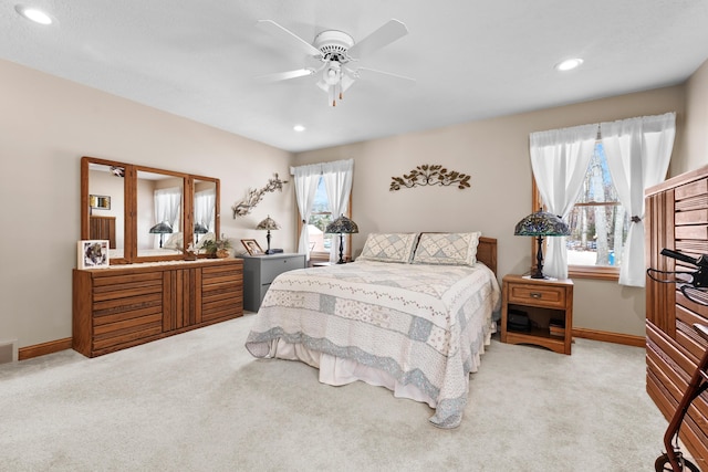 carpeted bedroom featuring recessed lighting, visible vents, baseboards, and a ceiling fan