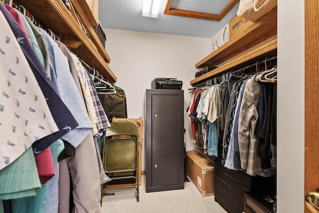 spacious closet with light carpet and attic access