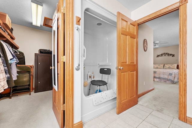 hall featuring carpet flooring and baseboards