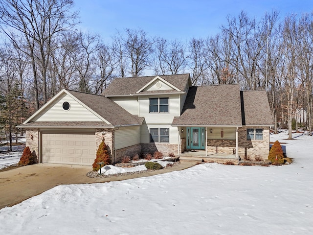 view of front of house with brick siding, an attached garage, and driveway