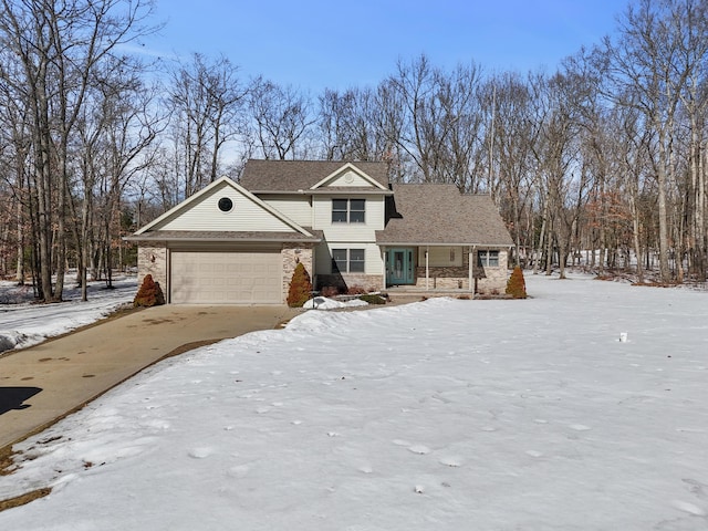 traditional-style house featuring an attached garage and driveway