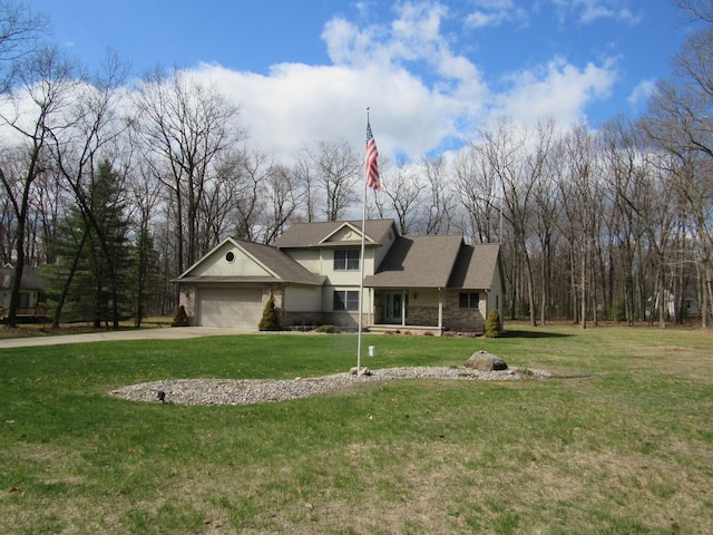 view of front of property featuring a front yard, stone siding, a garage, and concrete driveway