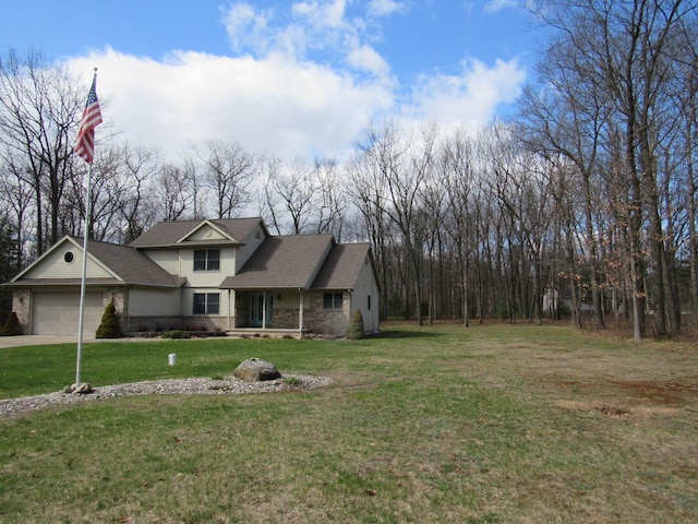 view of front of home with a front yard, a garage, and concrete driveway