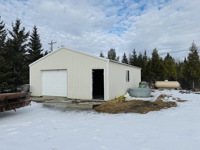 snow covered garage with a garage