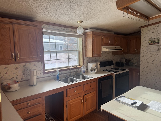 kitchen featuring wallpapered walls, range with gas cooktop, dishwasher, range hood, and a sink