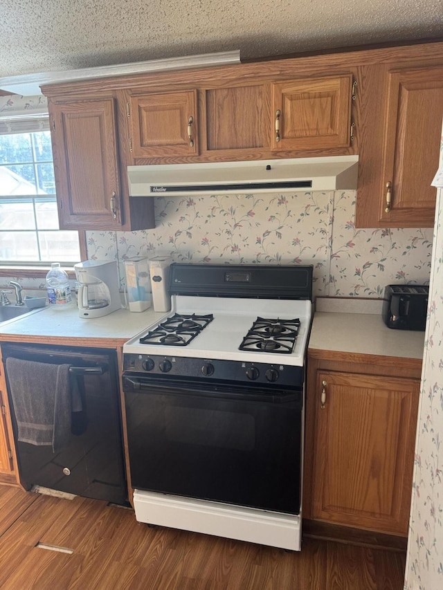 kitchen with range with gas cooktop, extractor fan, dishwasher, and light countertops