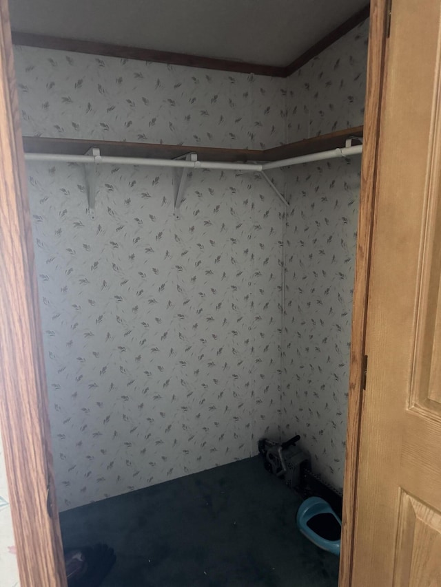 bathroom featuring wallpapered walls and crown molding