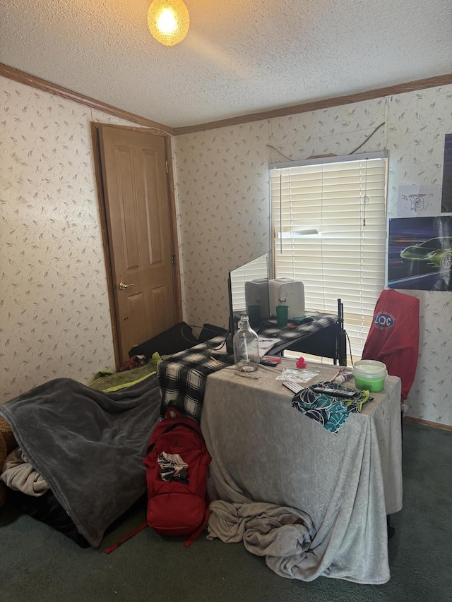 carpeted home office with a textured ceiling, ornamental molding, and wallpapered walls