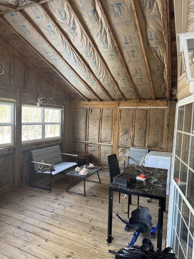 interior space with wood-type flooring and vaulted ceiling