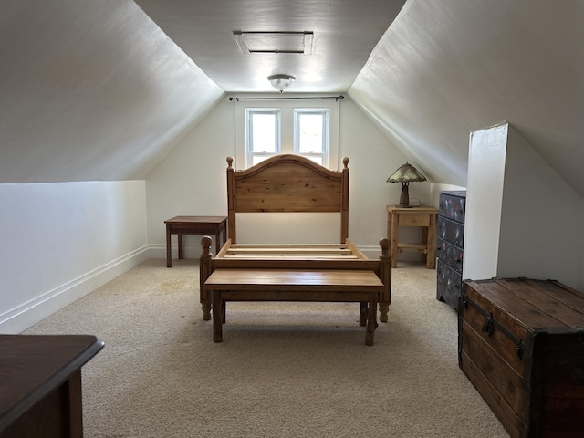 carpeted bedroom featuring baseboards and lofted ceiling