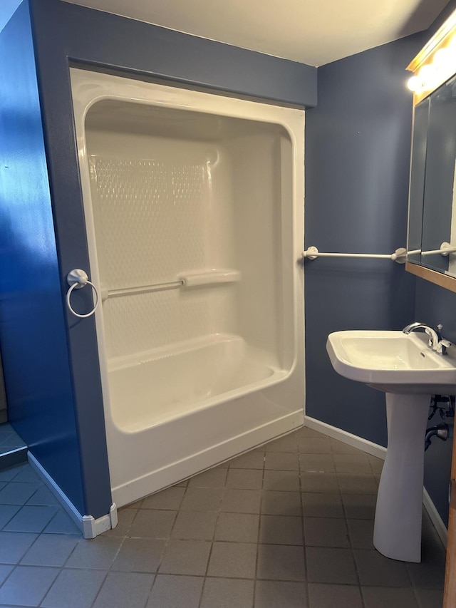 bathroom with baseboards and tile patterned flooring