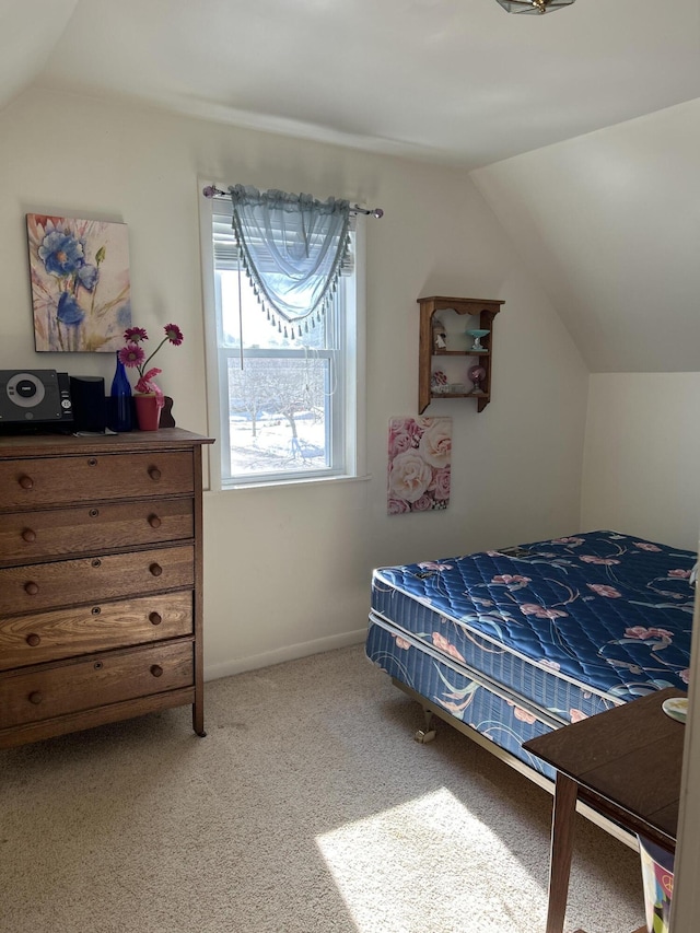 bedroom featuring carpet flooring, baseboards, and lofted ceiling