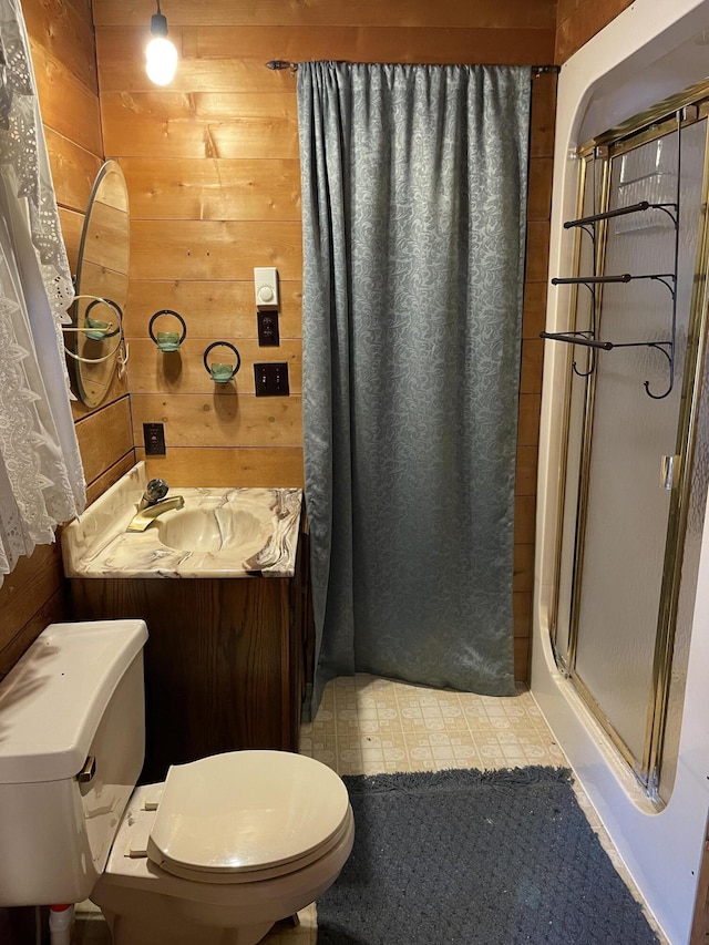 8610 Lincoln Bay Dr, Alpena, MI 49707 - full bathroom with wood walls, a stall shower, toilet, and vanity