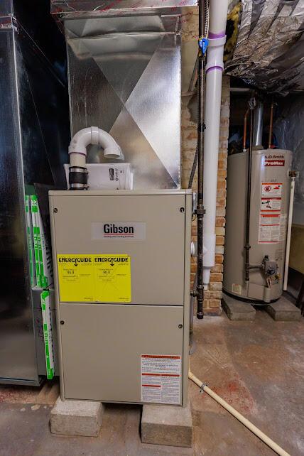 utility room featuring gas water heater