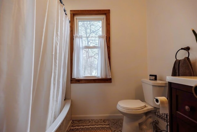 bathroom featuring vanity, baseboards, shower / bath combo, tile patterned flooring, and toilet